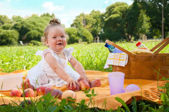 Adorable little girl on picnic in the beauty park