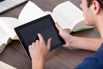 Male Student Using Digital Tablet