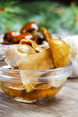 Pickled mushrooms in transparent glass bowl
