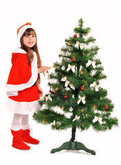 Little girl decorate a christmas tree