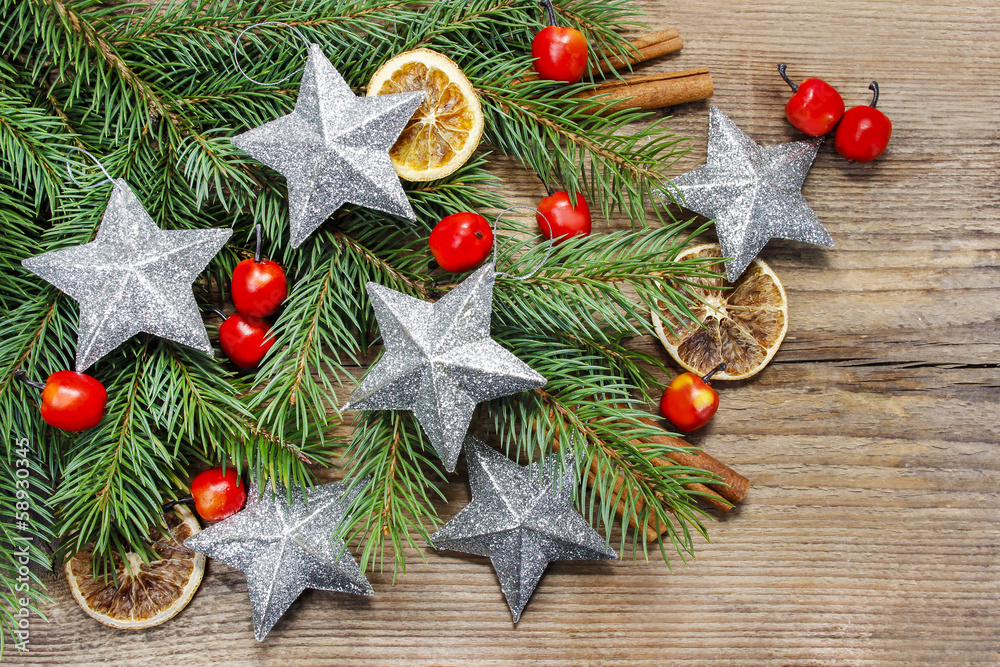 Wall mural beautiful christmas background: silver stars, apples and dried f