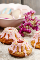 Traditional easter yeast cake covered with pink icing and colorf