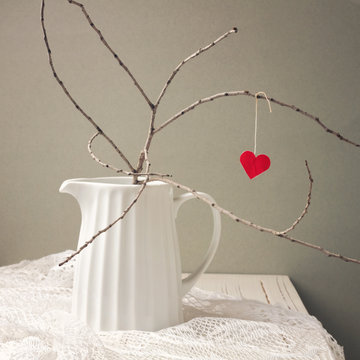 Paper heart hanging on tree branch. Valentine's Day concept.