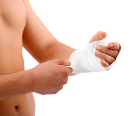 Young man with elastic bandage on hand, isolated on white