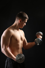 Fototapeta na wymiar Handsome young muscular sportsman execute exercise with