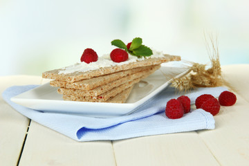 Tasty crispbread with berries, on white table