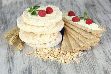 Tasty crispbread with berries, on wooden table