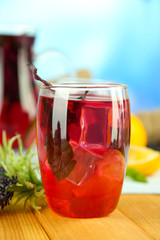 Red basil lemonade in jug and glass,