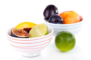 Fruit in small bowls isolated on white