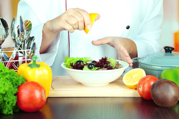 Cook hands prepare salad