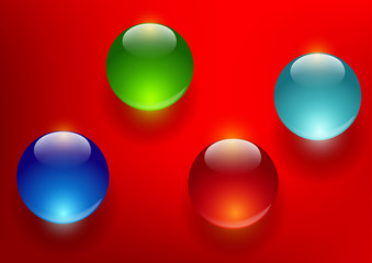 colorful glass balls on a red background