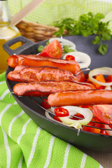 Delicious sausages with vegetables in wok