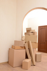 Fototapeta premium Empty room with stack of cartons: moving house concept