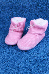 Warm winter home shoes on color background