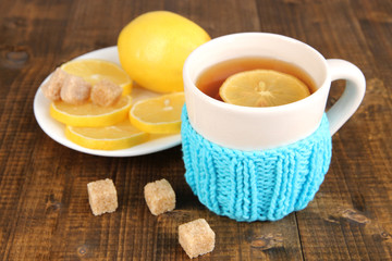Cup of tea with lemon on wooden table