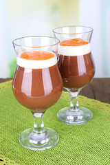 Dessert of chocolate and persimmon on table on light background