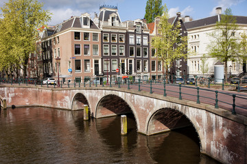Fototapeta na wymiar Bridge over Canal and Houses in Amsterdam