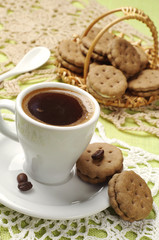 Cup of hot coffee and sweet cookies