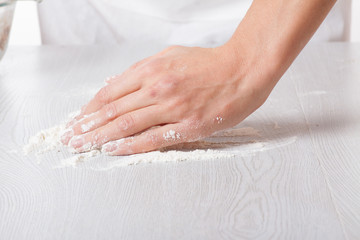 Hands and white wheat flour