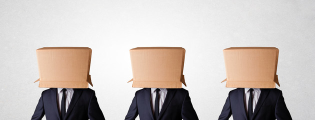 People gesturing with empty box on their head