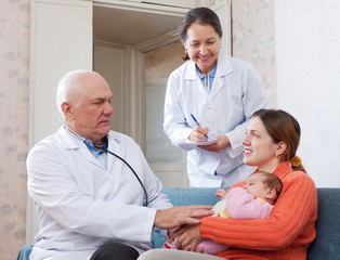 Fototapeta premium pediatrician doctor examining three months baby