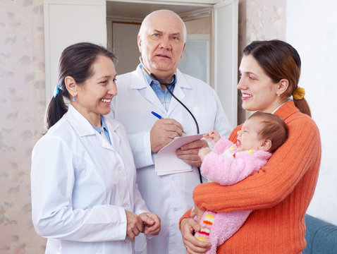   pediatrician doctors examining little baby