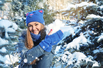 Winter woman play snowballs on snow background