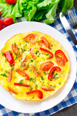Omelet with paprika, tomato and herbs