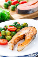 Salmon with roasted brussels sprout and tomato