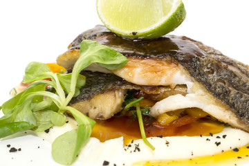 baked fish with vegetables and mushrooms in a restaurant