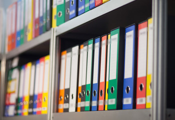 colorful folders on bookshelf