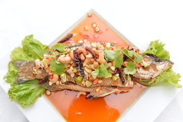 Thai food fried fish with spicy sauce isolated in white backgrou