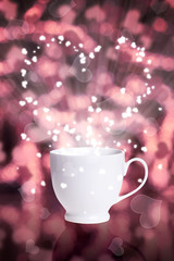 Fototapeta premium coffee cup against bokeh background with hearts