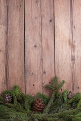 christmas tree branches with bumps on wooden background