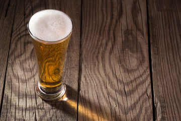 Mug of beer on wooden background