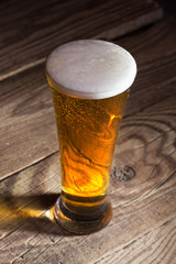Mug of beer on wooden background