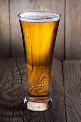 Mug of beer on wooden background