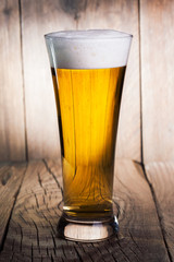 Mug of beer on wooden background