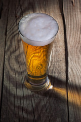 Mug of beer on wooden background