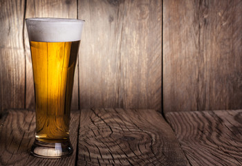 Mug of beer on wooden background