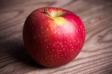 single apple on wooden background