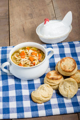 Chicken soup and biscuits on table