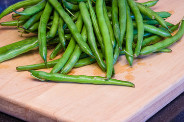Green beans on a wooden cutting board