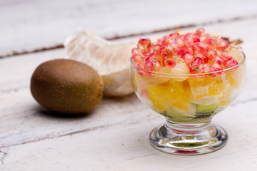 fruit salad, pomegranate, kiwi, orange, pomelo