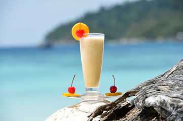 cocktail on the wood at the outdoor against tropic sea beach