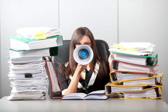 Business woman screaming with a megaphone
