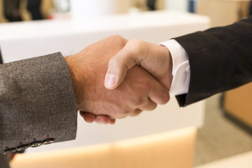 Handshake isolated on business office background