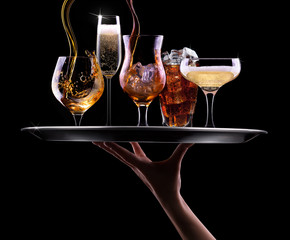 set with different drinks on black background