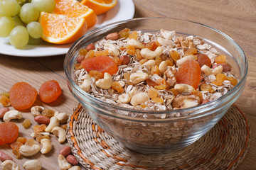 Cereal with raisins, nuts and dried apricots and fresh fruit