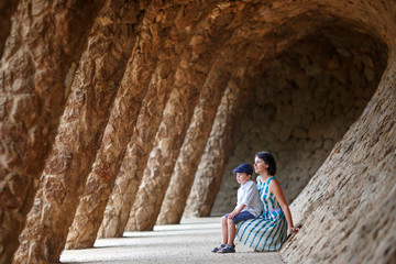 Fototapeta na wymiar Young mother and her son walking Park Guell